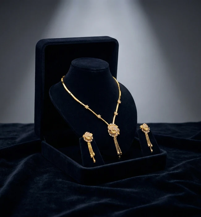 Gold necklace and earrings set on display